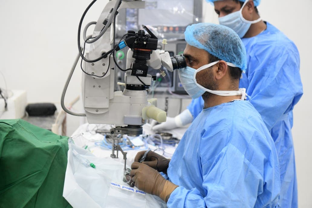 A surgeon operating at the microscope at Drishtipunj Eye Hospital
